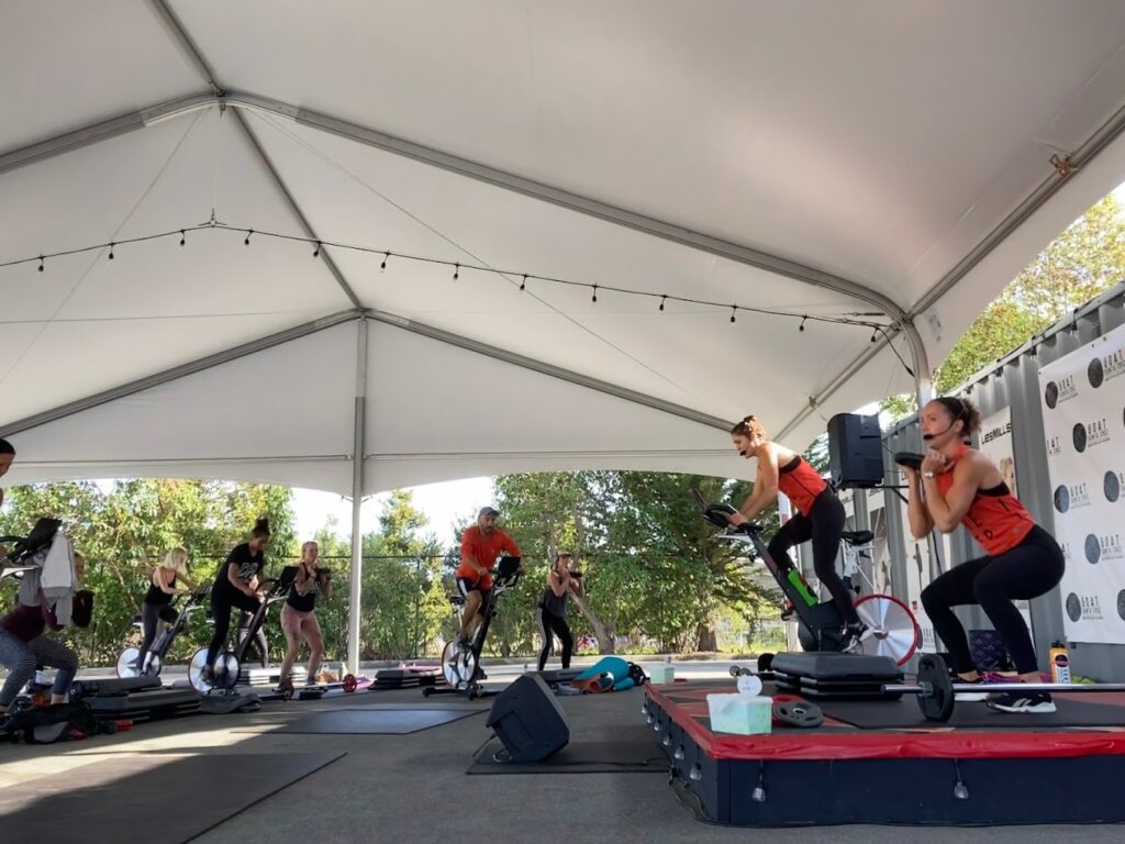 An open-air group workout under a canopy at GOAT Santa Cruz