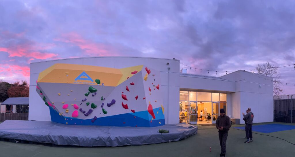 Agility Boulders’ outdoor climbing wall and gym entrance at dusk